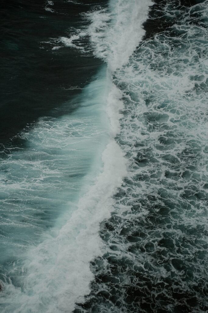 A stunning aerial shot of ocean waves captured from above, showcasing nature's raw power.
